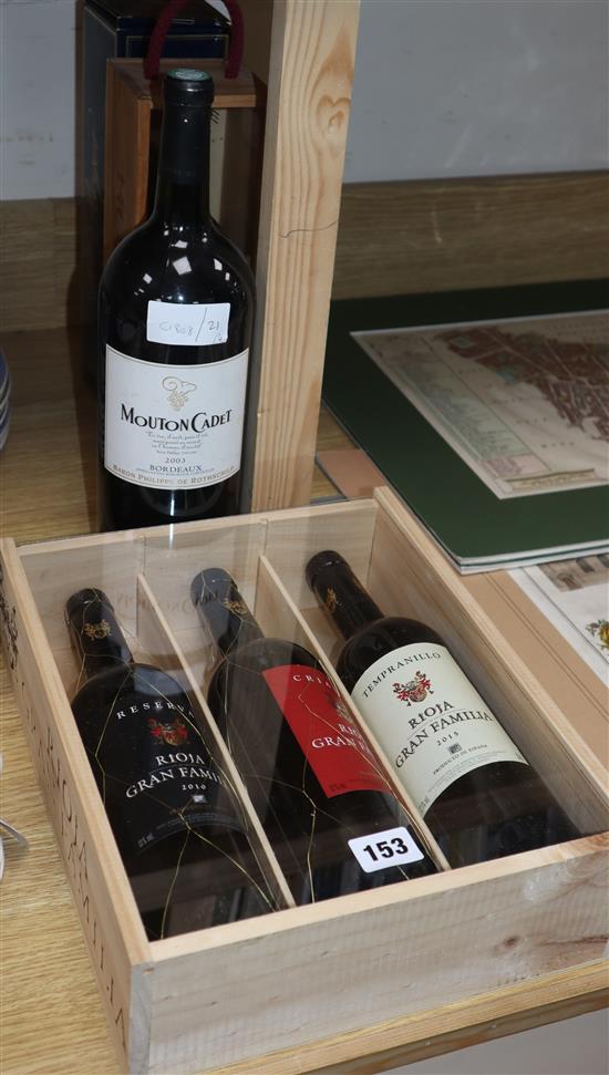 A magnum of Mouton cadet, 2003, a presentation box of three Spanish riojas, one Ch.la roseliere, 2006 and one Pol Roger champagne